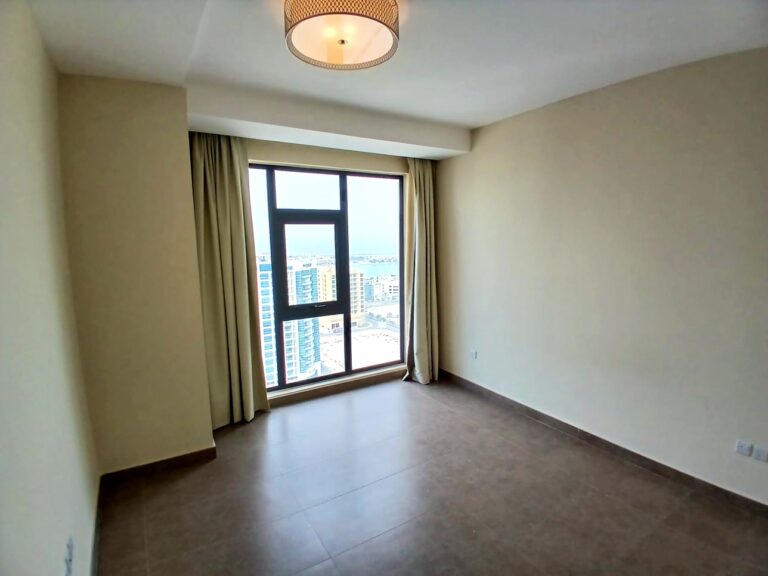 Spacious, empty room with a large window overlooking an Auto Draft cityscape.