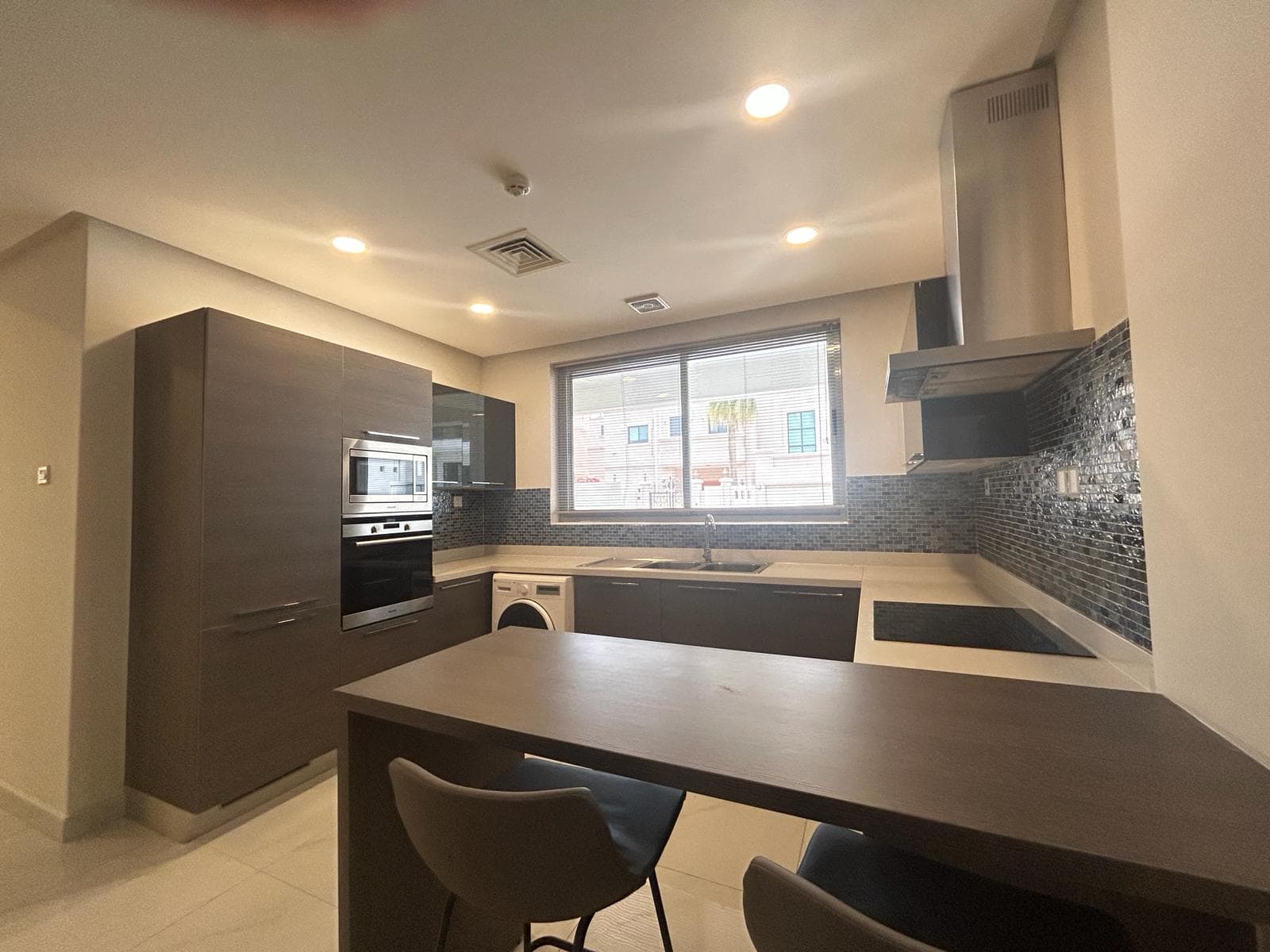 Modern kitchen interior with built-in appliances in a luxury fully-furnished 2 BDR apartment.