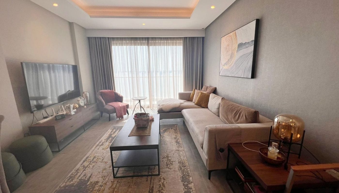 A luxurious living room with a flat screen TV and a coffee table for sale.