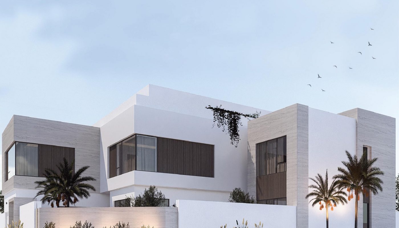 Modern two-story house with large windows, white and gray exterior, palm trees, minimal landscaping, and a white perimeter wall under a clear sky.