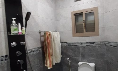 An apartment in Samaheej for sale featuring a bathroom with a shower and toilet.