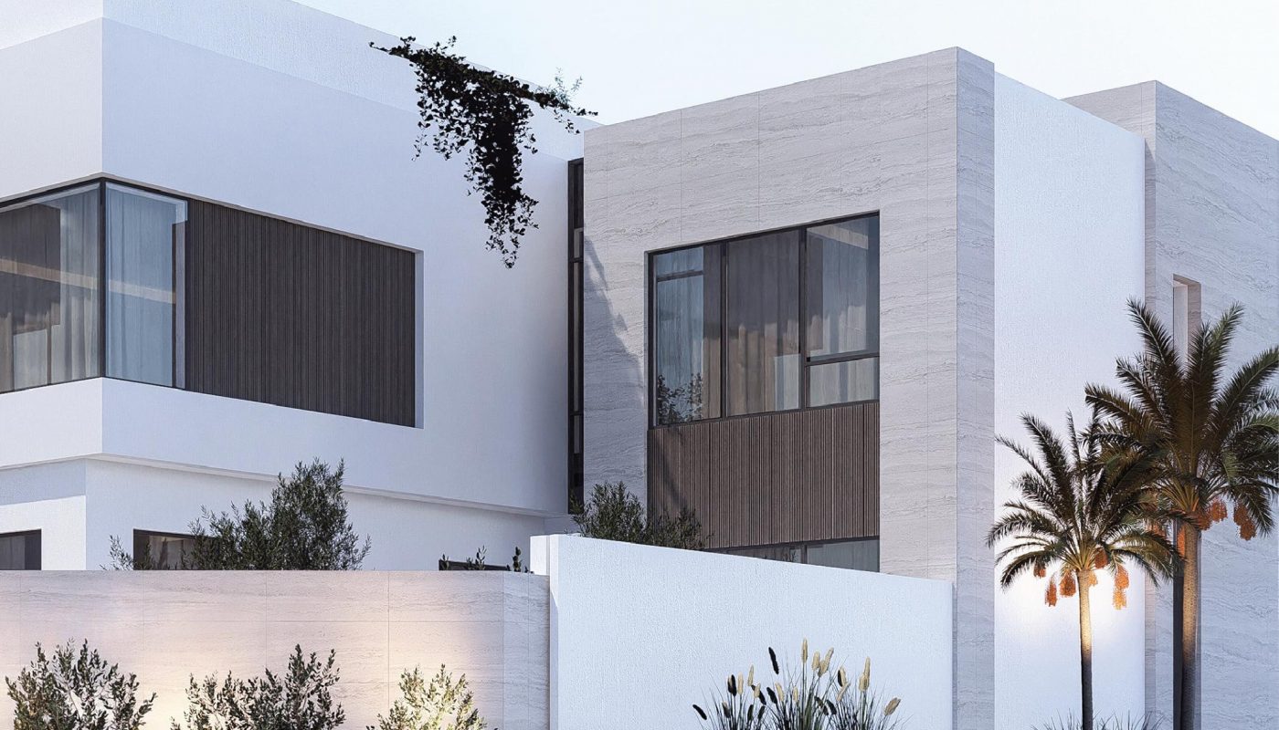 Modern two-story house with large windows, white exterior walls, wooden accents, palm trees, and landscaped plants along the front fence.
