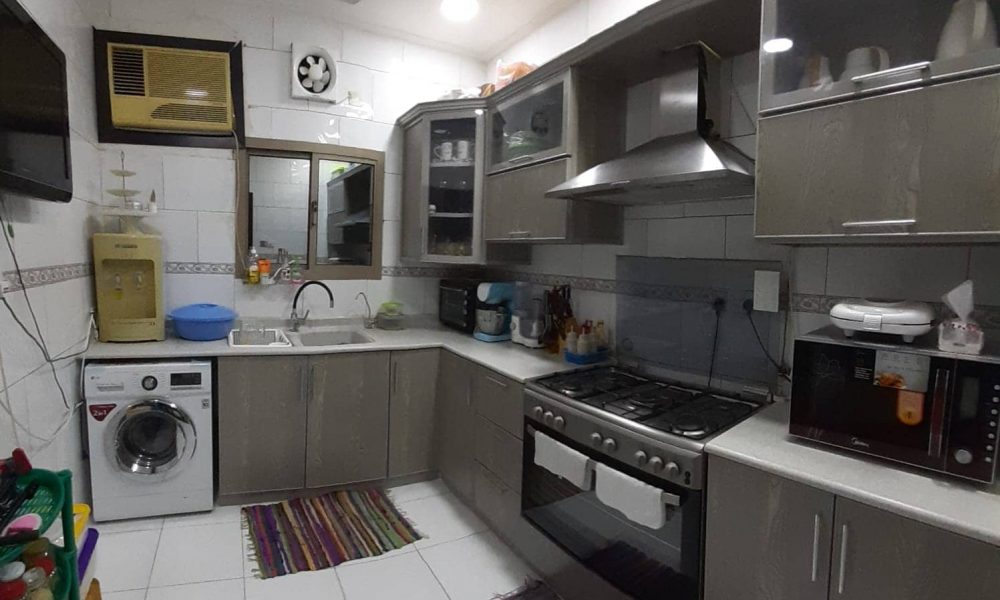 A kitchen with a sink and oven for sale.