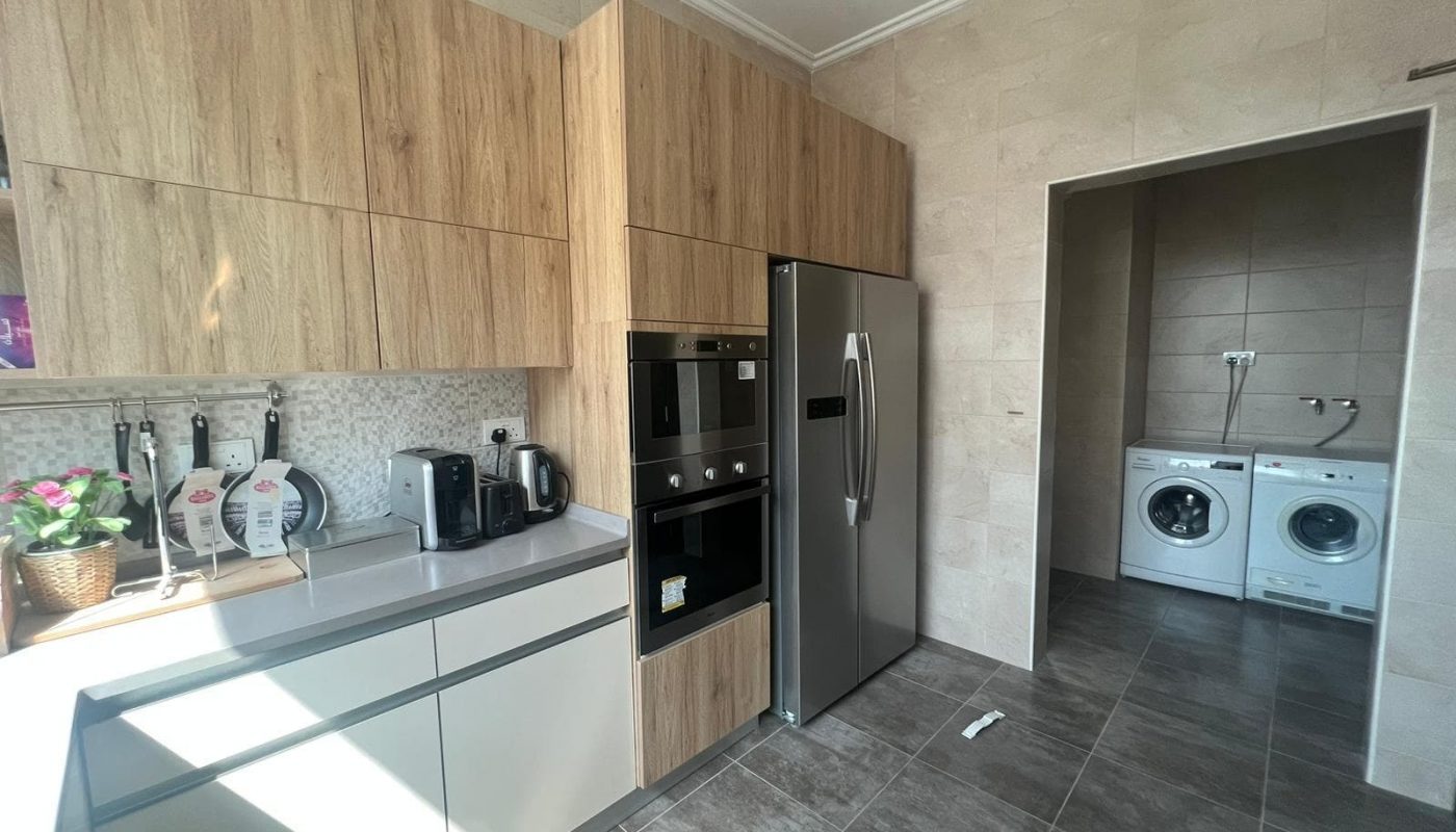 Spacious kitchen in modern 3BR apartment for sale in Hidd.