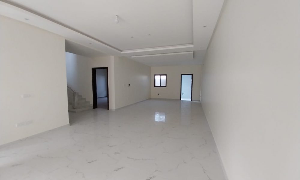 A white tiled floor in an empty room for sale.