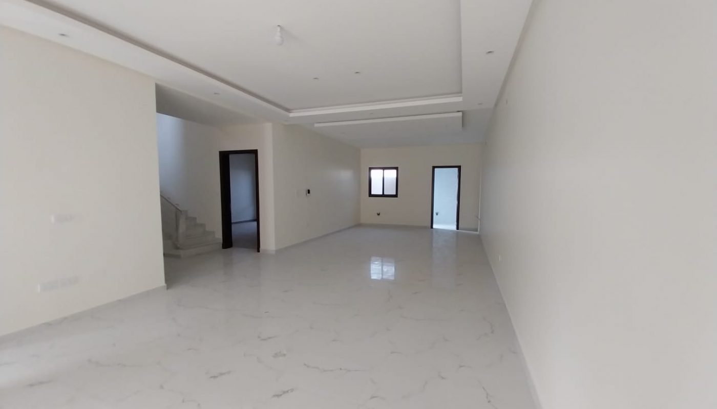 A white tiled floor in an empty room for sale.