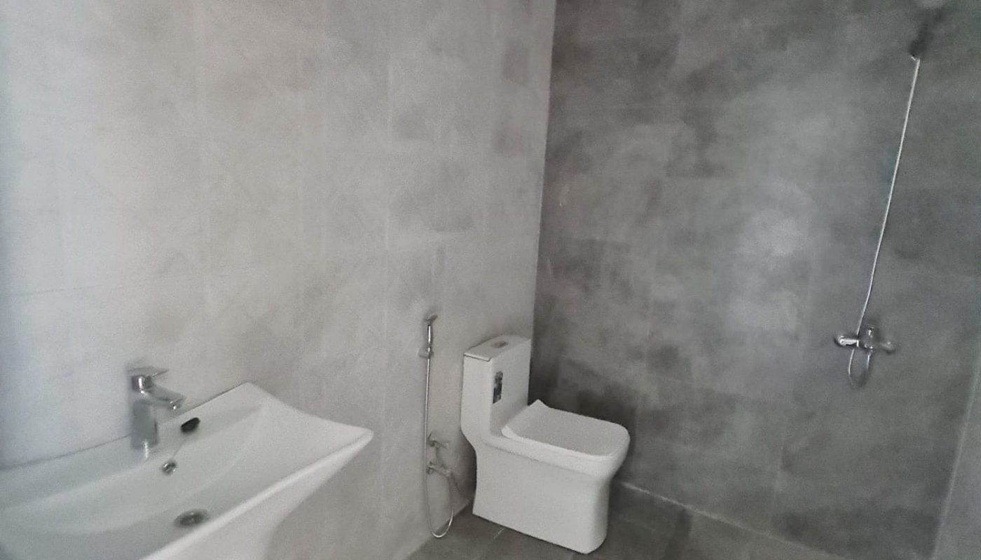 A bathroom in a stunning new villa for sale in Malkiyah, featuring a toilet and sink.