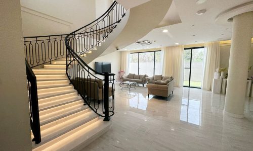 A modern villa in Hamala complete with three bedrooms, featuring a stylishly designed staircase leading up to a spacious living room.