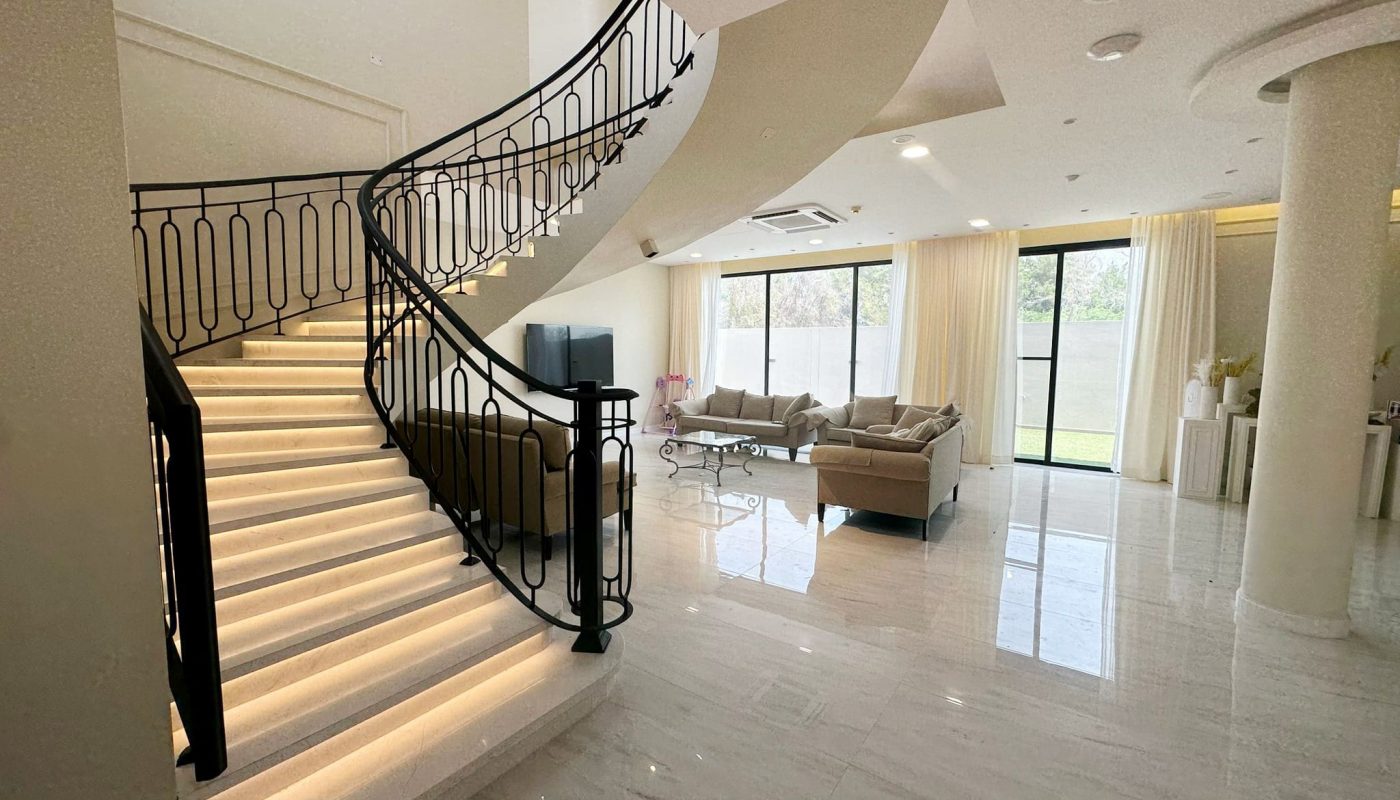 A modern villa in Hamala complete with three bedrooms, featuring a stylishly designed staircase leading up to a spacious living room.