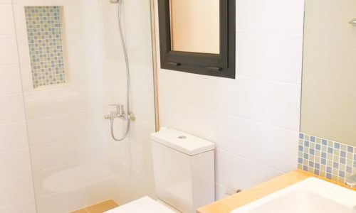 A stunning bathroom with a toilet, sink, and shower.