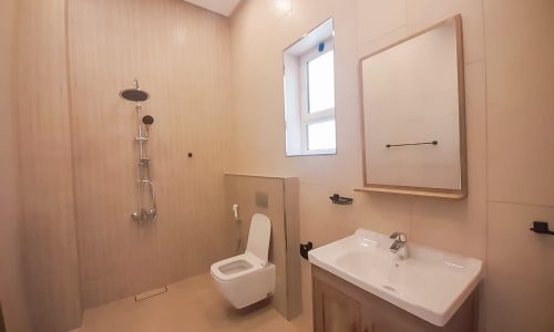 A stunning bathroom with a toilet, sink, and shower.