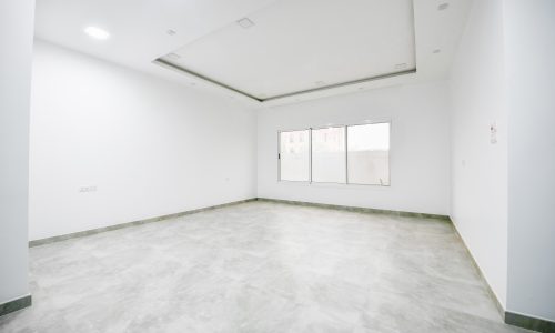 A spacious apartment with white walls and tile floors available for rent in Saar.