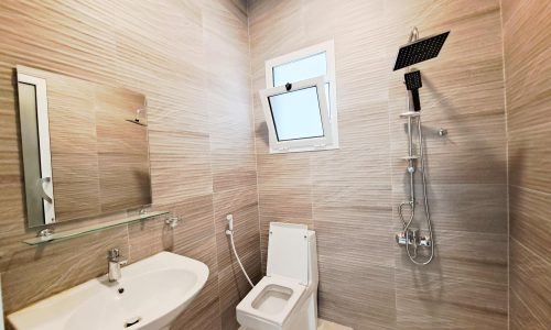 A luxurious bathroom with a toilet, sink, and shower.