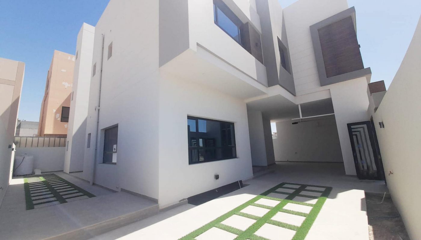 Stunning white house with grass in front of it.