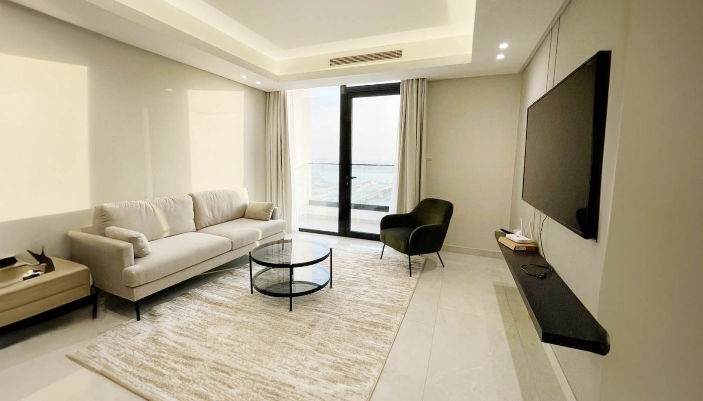 A white living room with a stunning ocean view.