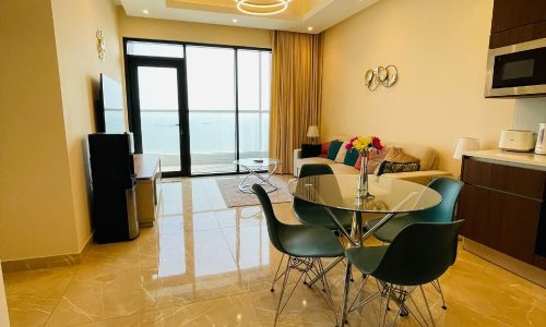 A living room and dining area with a view of the ocean, Auto Draft.