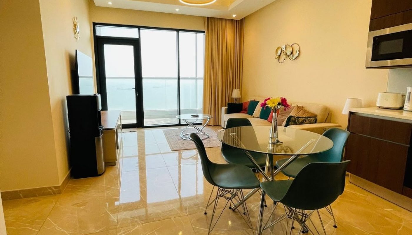 A living room and dining area with a view of the ocean, Auto Draft.