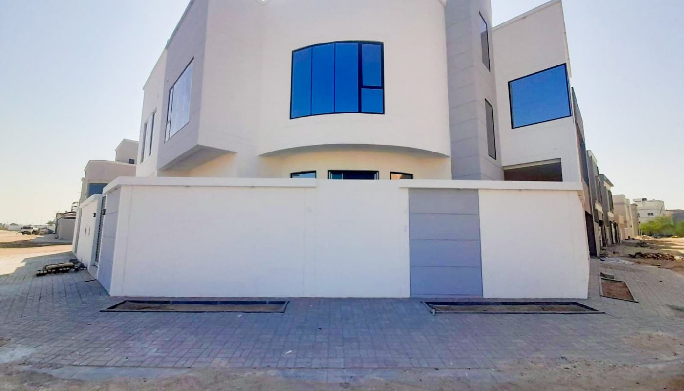 A luxury white building with a large window in front in Al Shakhura.