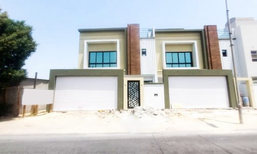 Amazing house with two garages in front of it.