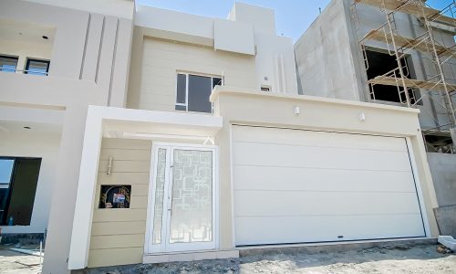 A stunning house under construction with a garage door.