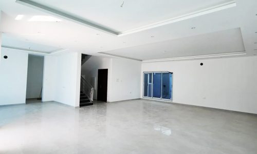 Luxury villa with white walls and floors available for sale in Bani Jamra, located near 1 Road.