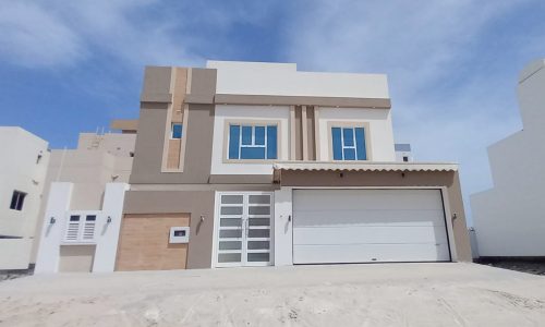 Ideal Location 4BR Villa for Sale in Bani Jamra with a garage in front.