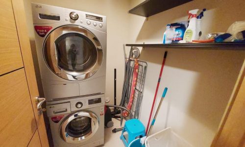 A modern laundry room with a washer and dryer.