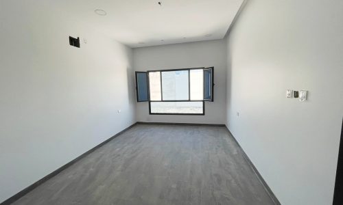 A bright room with wooden floors and a window.