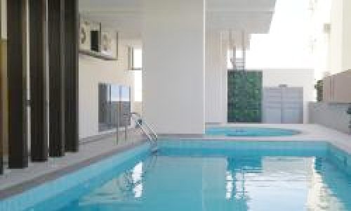 A luxury swimming pool in a modern apartment building.