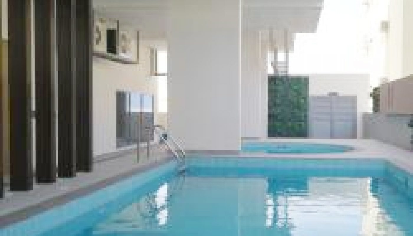 A luxury swimming pool in a modern apartment building.