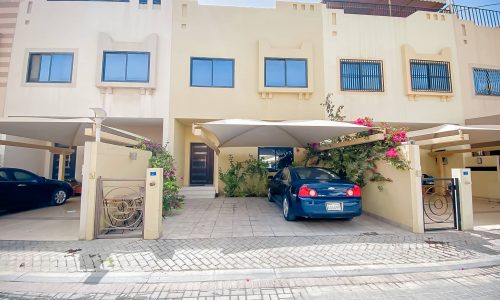 A 3BR villa for sale with a car parked in front of it.