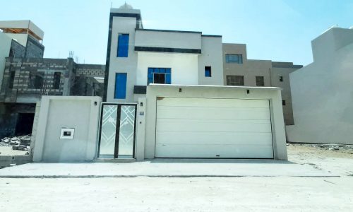 A luxury house with a garage in front of it.