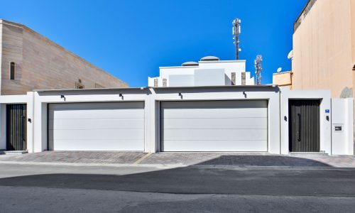 A luxurious villa with a white building against a blue sky.