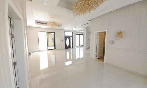 A luxury villa with a chandelier in the middle of the room.