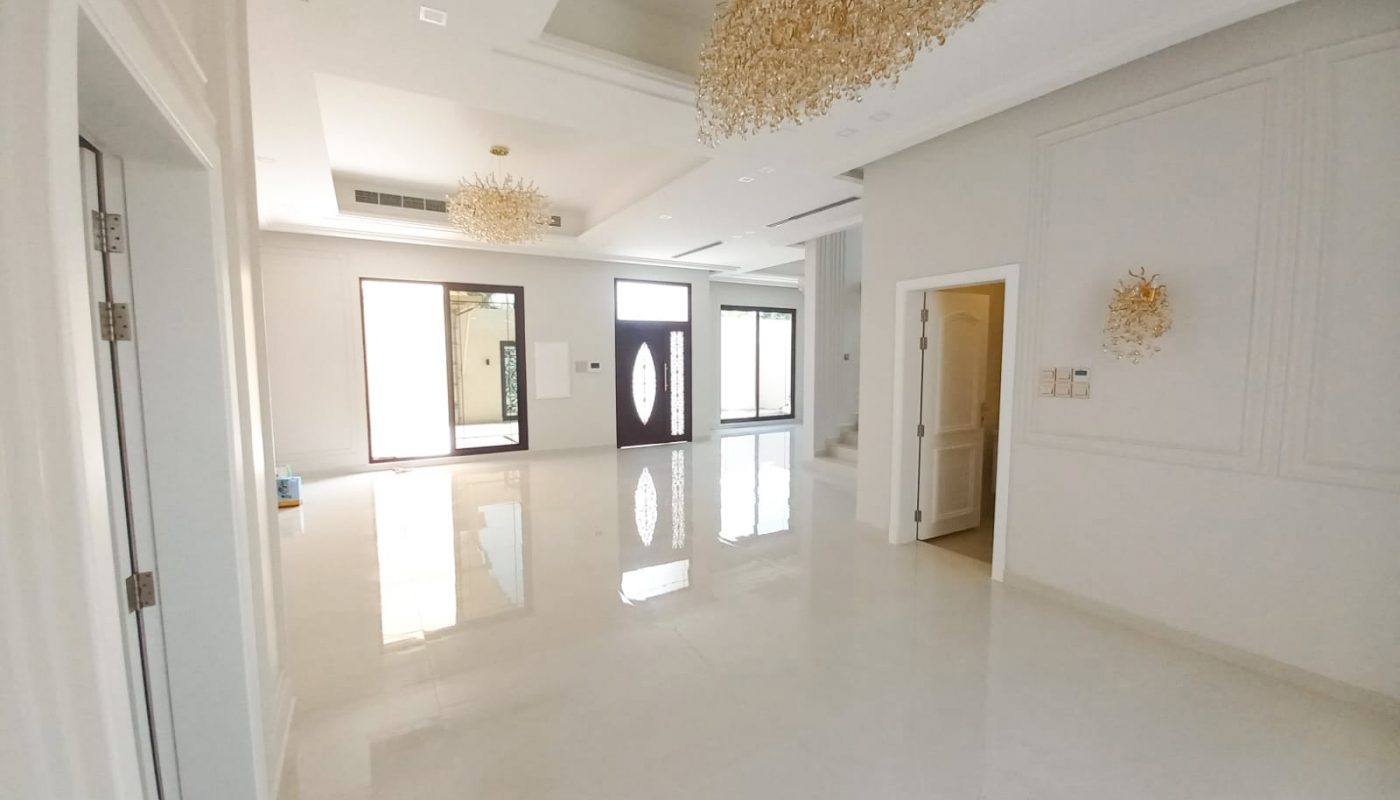 A luxury villa with a chandelier in the middle of the room.