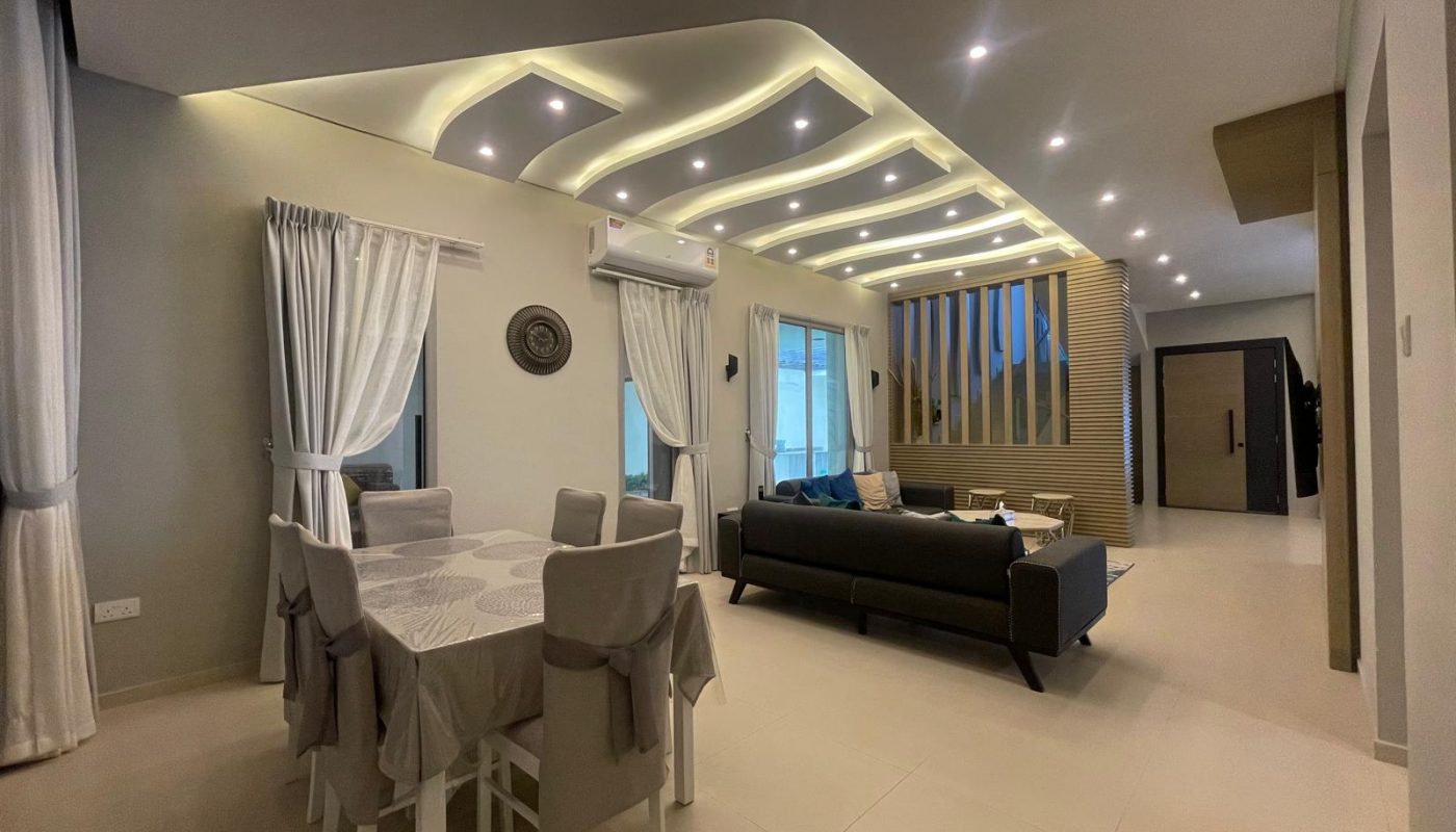Modern open-plan living and dining area with neutral tones, ceiling with built-in lights, contemporary furniture, and large windows with white curtains.