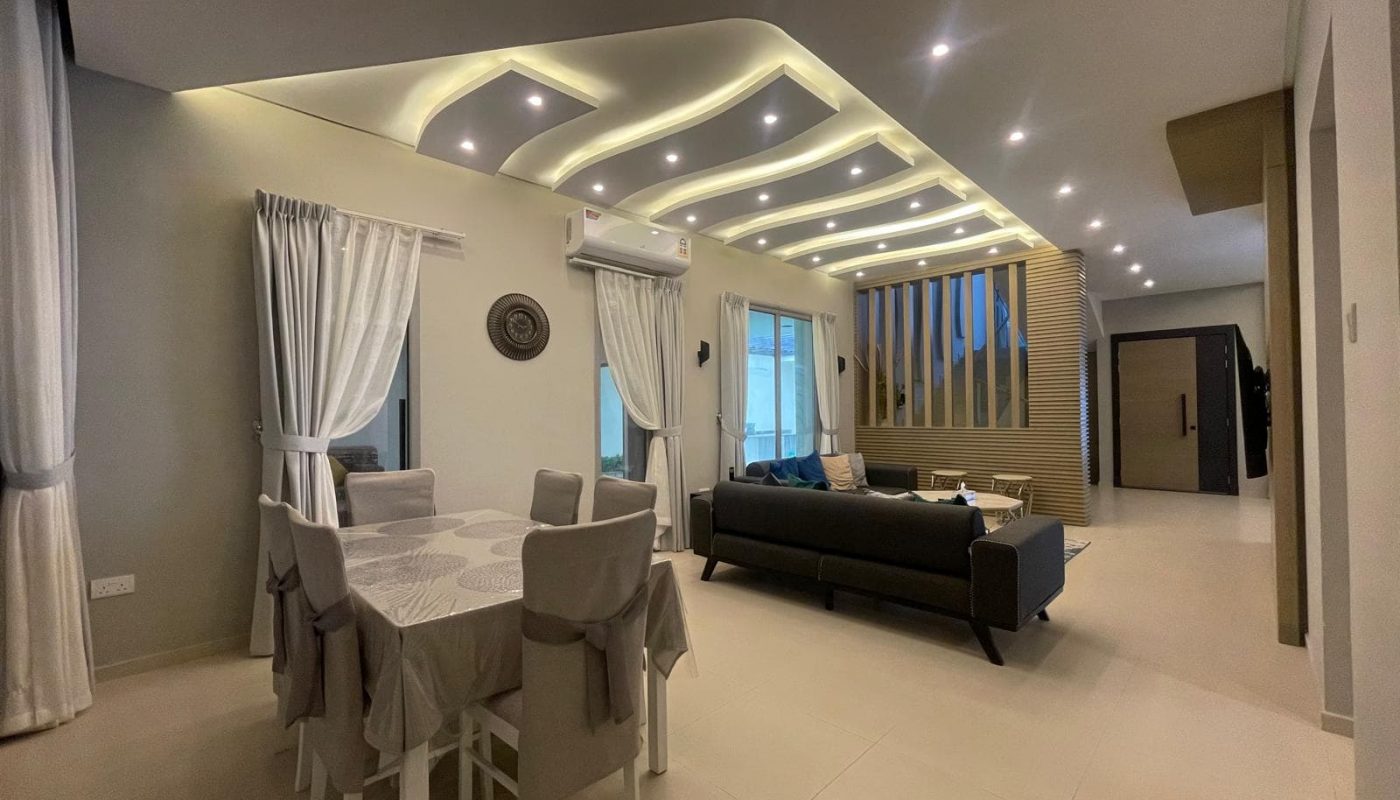 Modern open-plan living and dining area with neutral tones, ceiling with built-in lights, contemporary furniture, and large windows with white curtains.