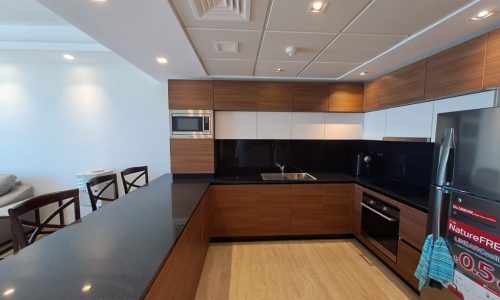 A Dilmunia Island apartment available for rent with stainless steel appliances and wooden cabinets.