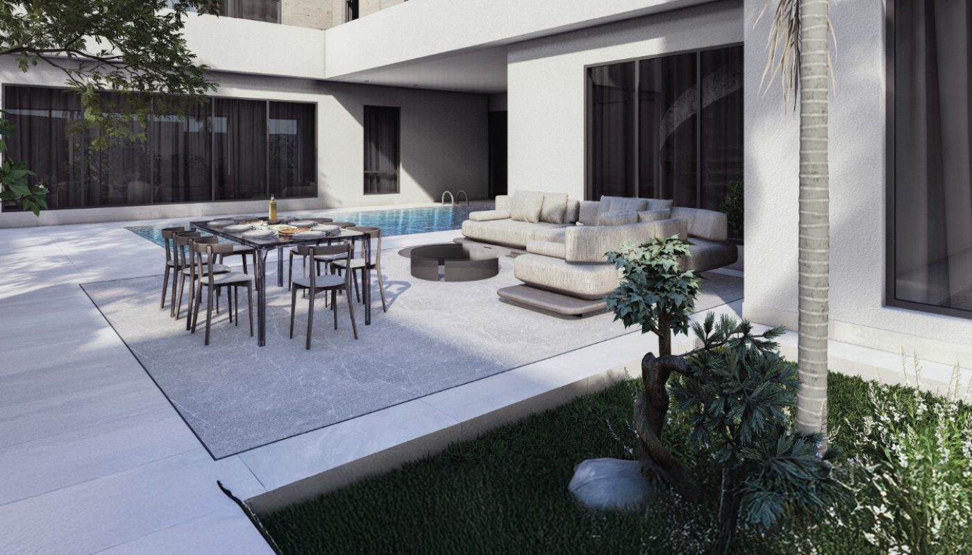 Modern courtyard with a swimming pool, outdoor dining table, beige sectional sofa, and palm tree surrounded by green grass and plants.