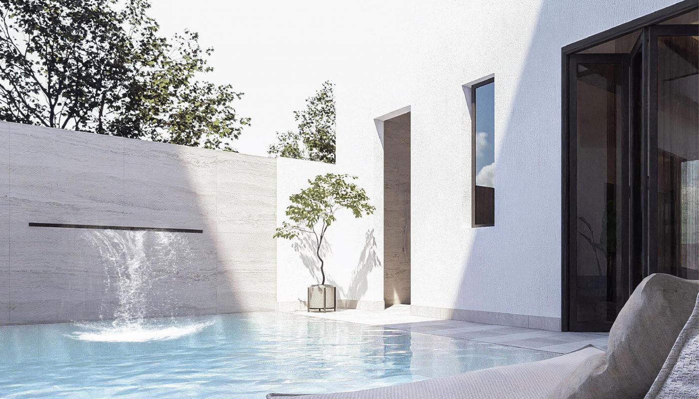Modern outdoor pool area with a lounge chair, glass table, small tree, and waterfall feature against white walls and partial sunlight.
