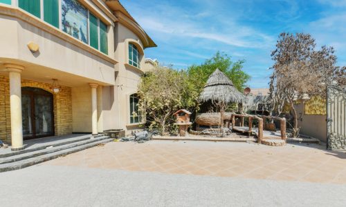 A spacious house in the middle of a desert.