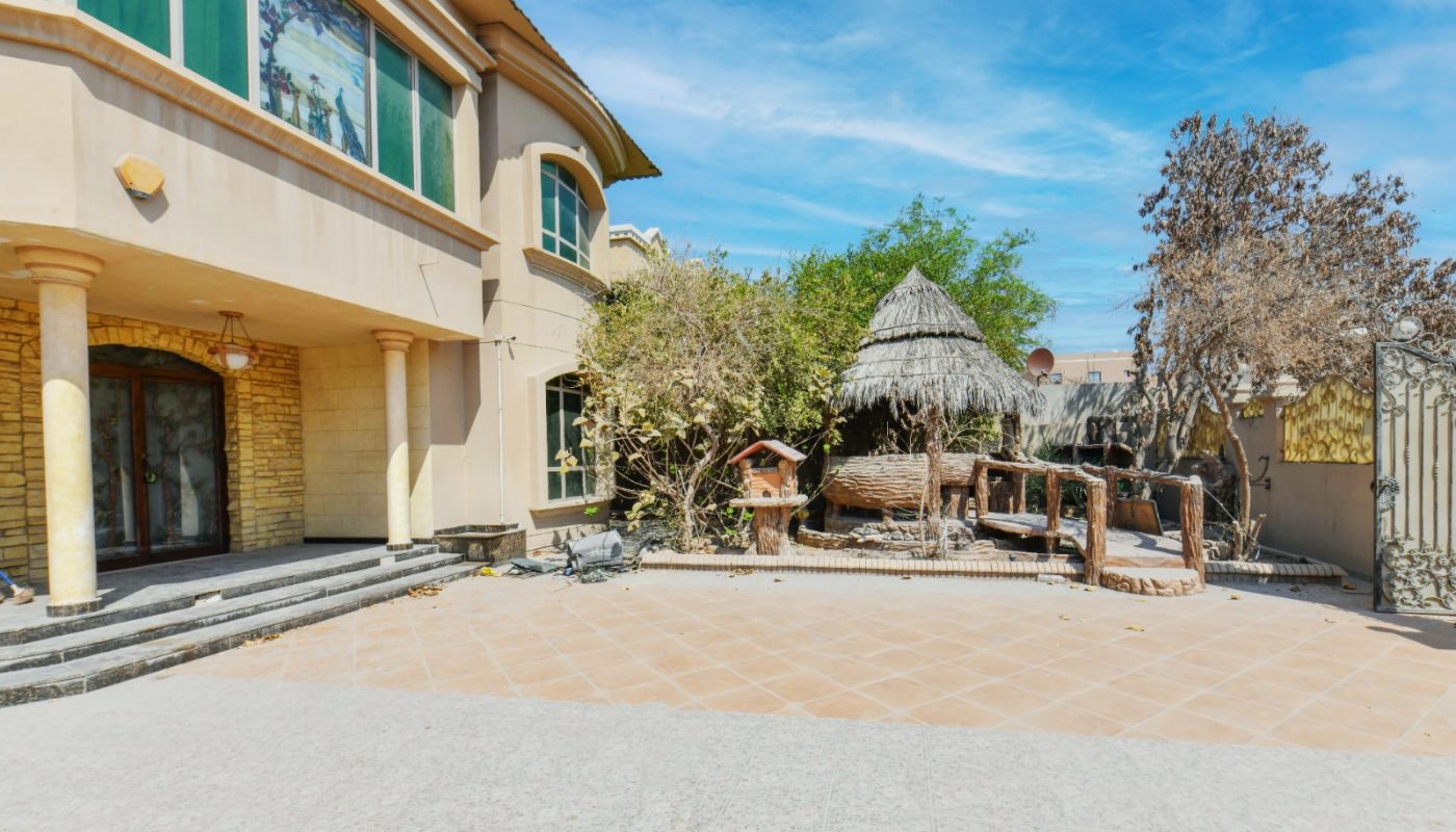 A spacious house in the middle of a desert.
