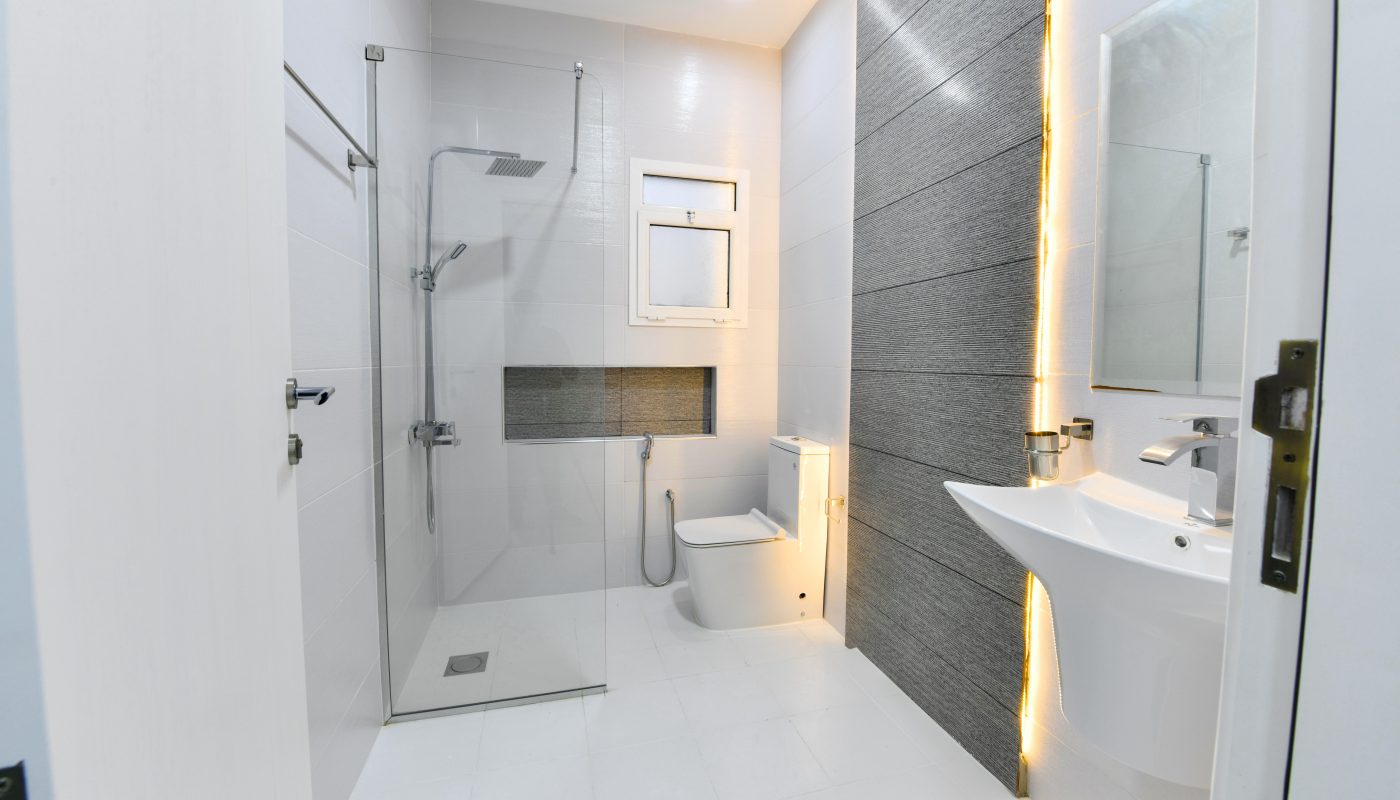 A luxurious apartment for sale with a white bathroom featuring a toilet and sink.