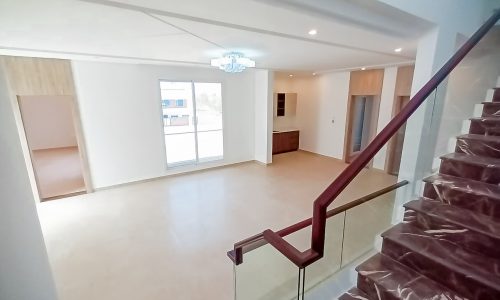 An amazing house with stairs leading to a large living room.