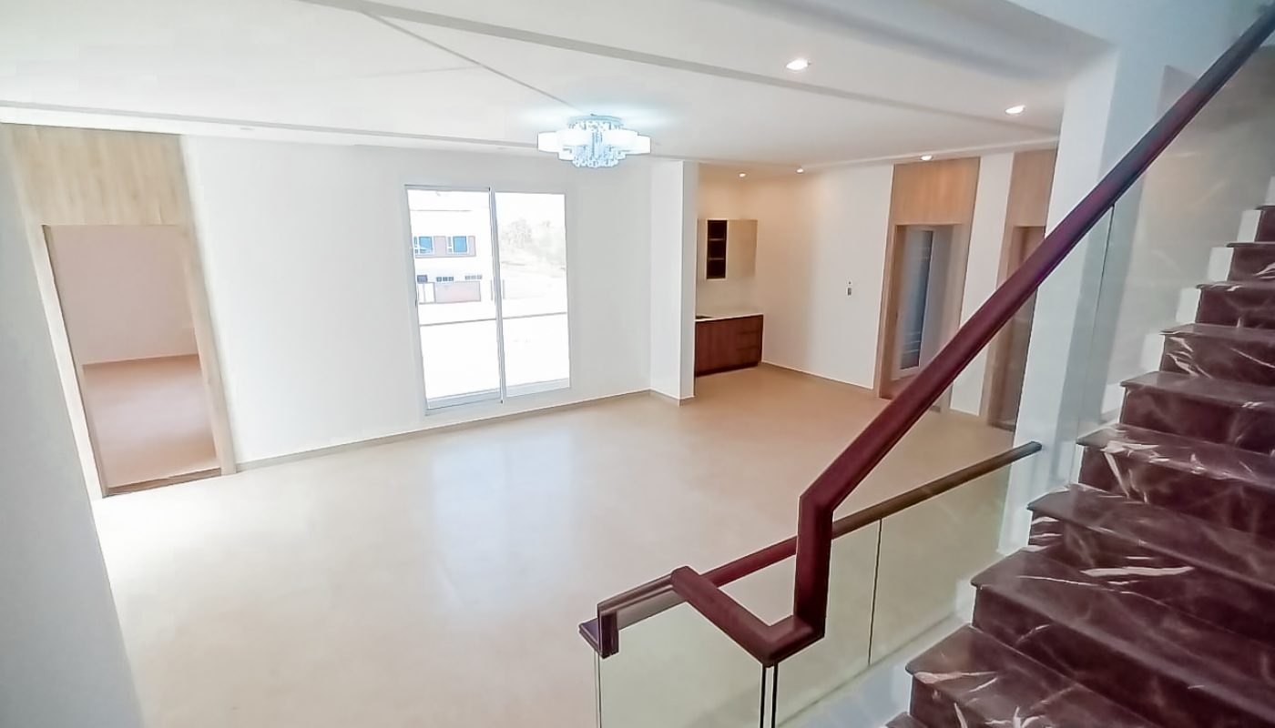 An amazing house with stairs leading to a large living room.