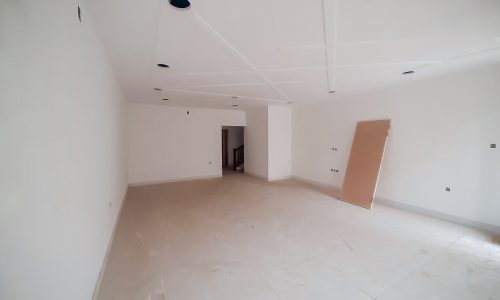A luxurious, empty room with white walls and a white floor.