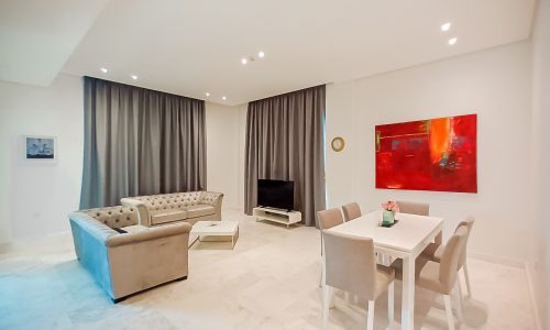 A residential living room with a dining table and chairs in Janabiyah.