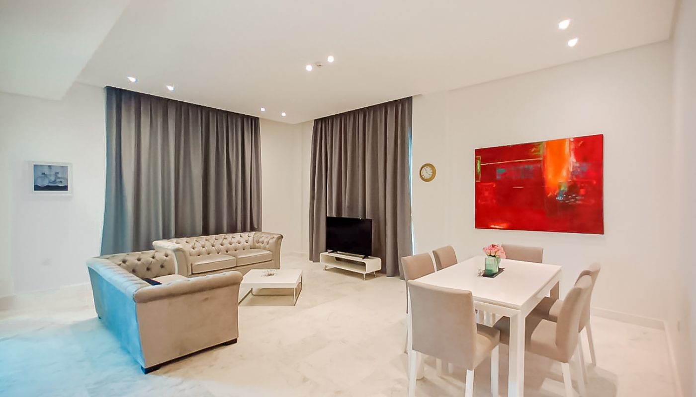 A residential living room with a dining table and chairs in Janabiyah.