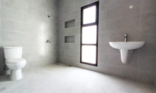 A villa for sale in Jid Al Haj featuring an amazing bathroom with a toilet and sink.