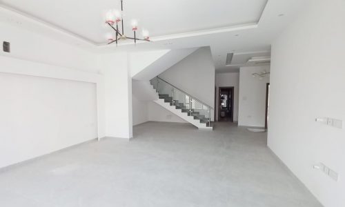 A spacious empty room with white walls.